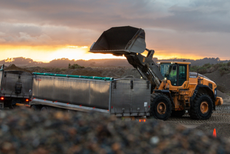 Front end loader filling a truck and trailer